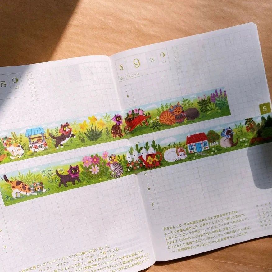 Open book with colorful illustrations on a wooden surface