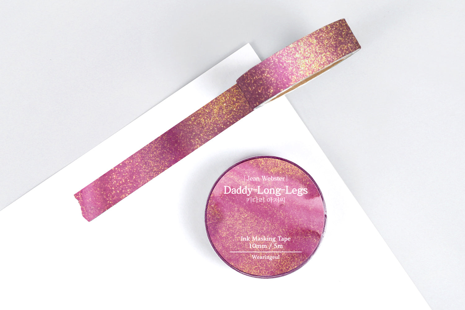 Pink and gold masking tape with a container labeled 'Daddy Long Legs' on a white background