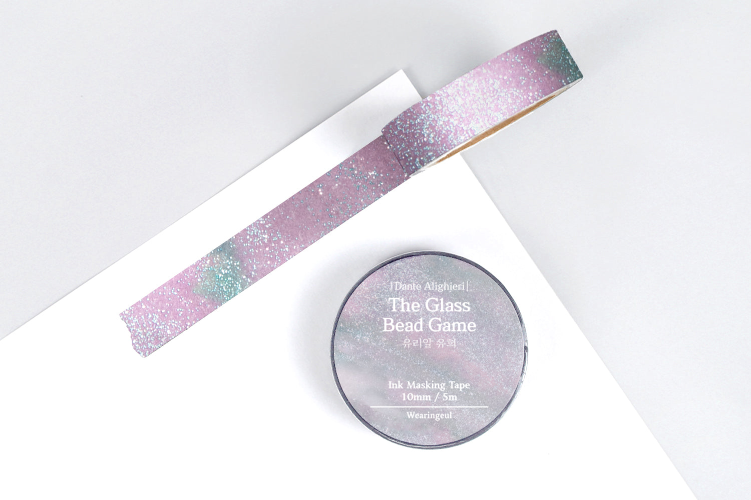 Decorative masking tape with a pink and blue sparkly design on a white background