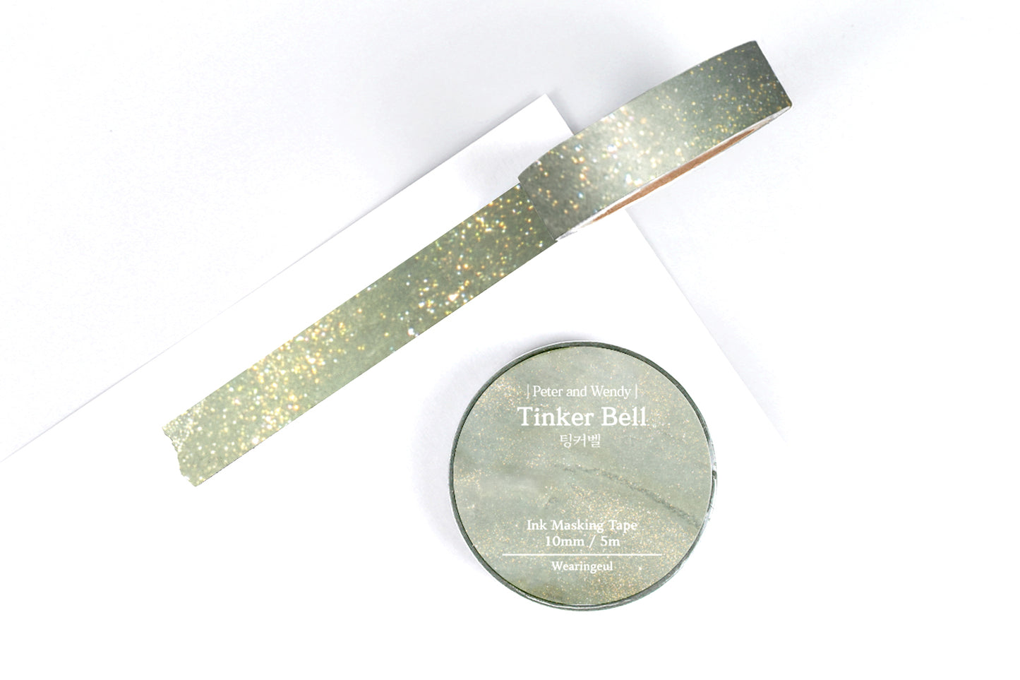 Sparkly green masking tape on a white background