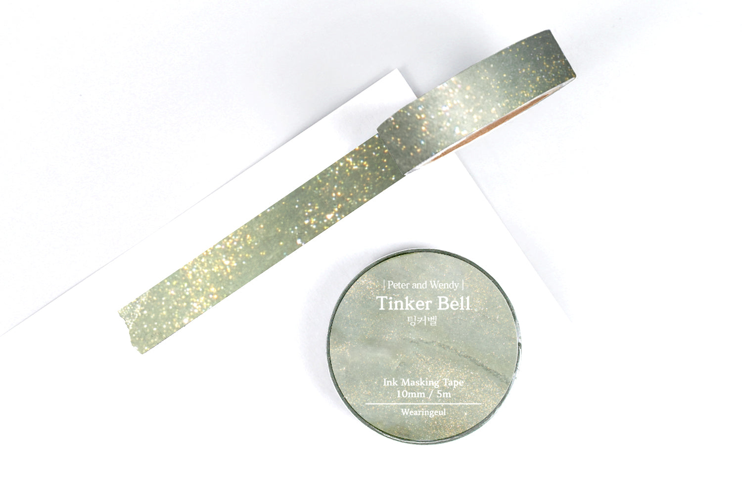 Sparkly green masking tape on a white background