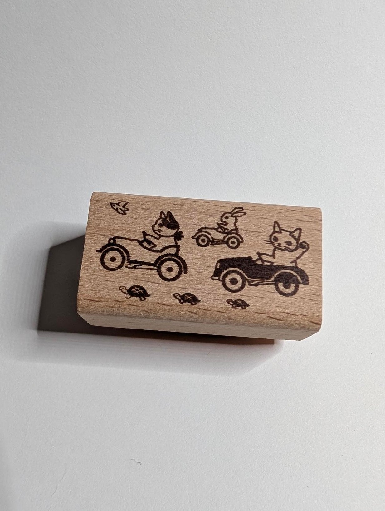 Wooden stamp with cat designs on a white background